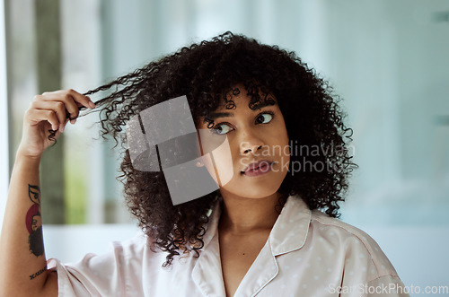 Image of Morning, natural and black woman with hair care bathroom routine feeling curly hair texture. Beauty, self care and african girl thinking of cosmetic treatment in home with thoughtful face.