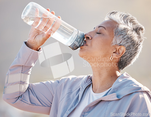 Image of Fitness, wellness and senior runner drinking water for hydration on outdoor run, marathon training or cardio workout. Sports exercise, bottle and profile of thirsty woman running in Miami Florida USA