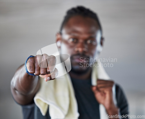 Image of Fist, boxer and martial arts with black man and fitness, sports and boxing with exercise and hand zoom. Athlete, wellness and MMA fighter with towel, workout and training with sport motivation