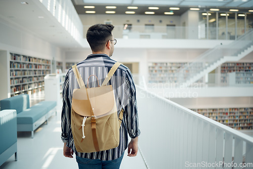 Image of Backpack, library and study with a man student walking in a university bookstore for education or learning. Back, college and research with a male pupil taking a walk in search of reading books