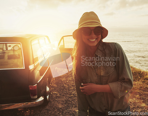 Image of Woman, road trip and smile for sunset journey, travel or vacation with a view of the ocean in outdoor nature. Happy female traveler smiling in happiness for summer with lens flare for a beach drive