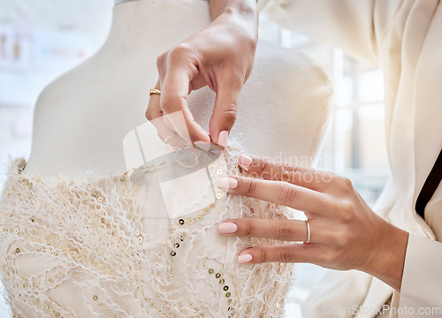 Image of Hands, design and woman designer with needle for dress, pattern and details while fabric in her studio. Fashion designer, hand and creative businesswoman working on luxury, classic and elegant wear