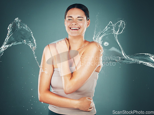 Image of Beauty, skin and skincare water splash on woman cleaning body for hygiene and hydration isolated in a studio background. Self care, wellness and female dermatology for young beautiful adult