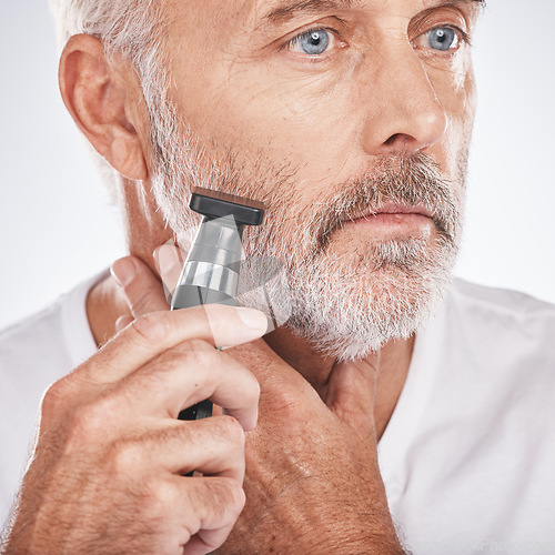 Image of Senior man, shaving and electric razor for hair care, beauty and cosmetics on studio background. Mature male, elderly guy and shave for facial routine, beard trim and wellness for health and skincare
