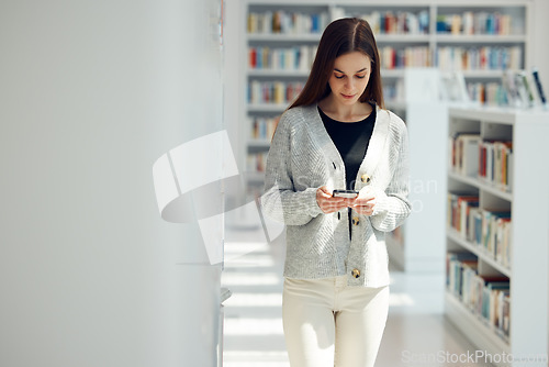 Image of Phone, library and woman networking on social media, mobile app or the internet with mobile. Books, knowledge and young female student typing or reading a text message on her cellphone at university.