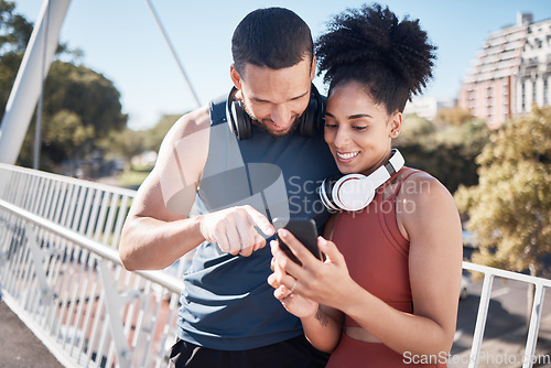 Image of Fitness, exercise and black couple with phone in city for running, marathon training and workout on bridge. Love, sports and man and woman on smartphone for social media, music and health mobile app