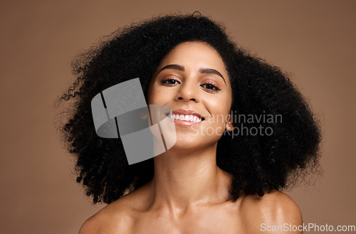 Image of Black woman, portrait and happiness for skincare wellness, natural curly hair care and cosmetics dermatology in brown background studio. African girl, smile and luxury self care beauty or body glow