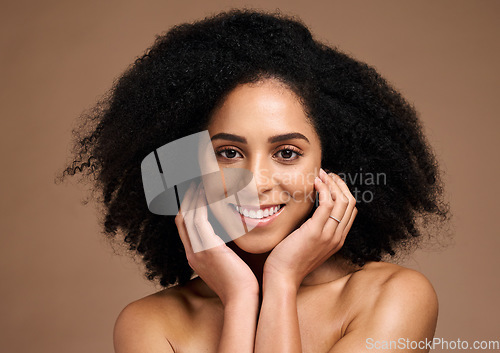 Image of Black woman, studio portrait and skincare for beauty, makeup and cosmetic health with hands, face or natural hair. Model, smile and facial skin cosmetics, self care or afro by brown studio background