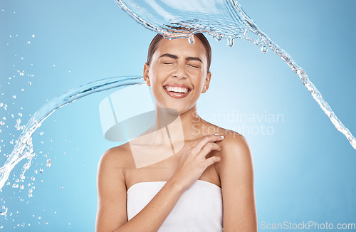 Image of Woman skincare, laughing or water splash on blue background studio for shower healthcare wellness, Brazil hygiene maintenance or self care grooming. Happy smile, beauty model and cleaning water drop