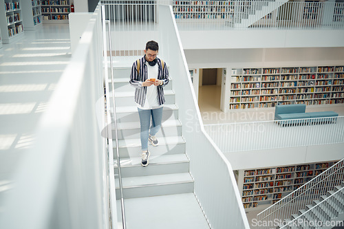 Image of College student, walking stairs and campus with phone, reading and communication on social media. Man, university student and smartphone app for email in library for education, learning and studying