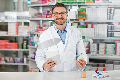 Image of Portrait, tablet and healthcare with a pharmacist man at work in a pharmacy for pharmaceutical medication. Medicine, trust and pills with a male working in a medical dispensary for treatment or cure