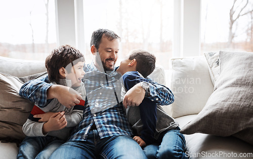 Image of Hug, playful and father with children on the sofa for love, care and relax in their family home. Happy, funny and dad with boy kids for quality time, affection and comedy on the couch of a house