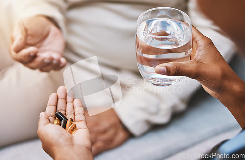 Image of Hands of nurse with patient for pills, water and medication in nursing home for wellness, healthcare and prescription. Doctor, medical care and health worker with vitamins, supplements and treatment