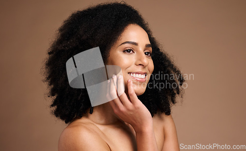 Image of Black woman, smile and studio with beauty, makeup and cosmetic wellness with hands, face glow and afro hair. Model, skin health and facial cosmetics, self care and aesthetic by brown studio backdrop