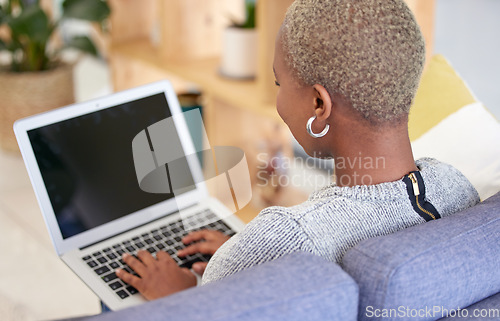 Image of Black woman, blank laptop screen and relax on sofa for marketing mockup, online advertising and digital communication in home. African woman, typing on keyboard and empty web homepage for connection