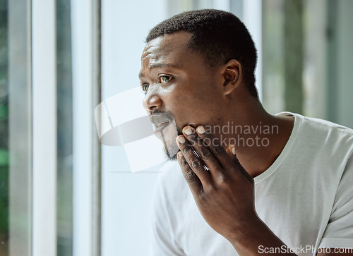 Image of Skincare, black man and acne stress at mirror in home bathroom with worried and confused face. Unhappy man checking pimple and blackhead problem in reflection with morning grooming routine.