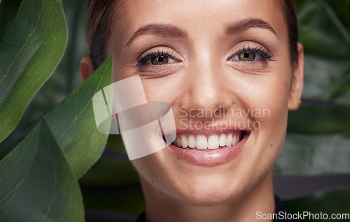 Image of Beauty, skin and face with leaf and woman, skincare with nature aesthetic, natural cosmetics and facial portrait against studio background. Smile, glow with organic cosmetic treatment and wellness.