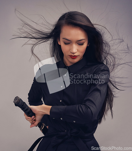 Image of Samurai, ninja and woman with sword in studio isolated on a gray background. Face, sports and martial arts meditation of young female warrior holding blade ready for workout, training or exercise