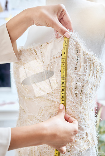 Image of Hands, fashion and measuring tape by woman designer for dress, pattern and details of fabric in studio. Creative, girl and measurement by dressmaker working on luxury, elegant and classic clothing