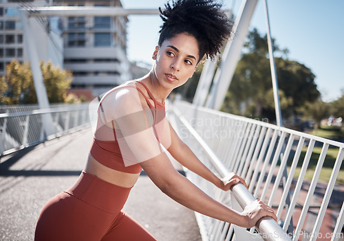 Image of Black woman, fitness and stretching, running in city and exercise outdoor, focus and strong with muscle training. Runner, athlete and sport motivation, person on bridge for run and health wellness