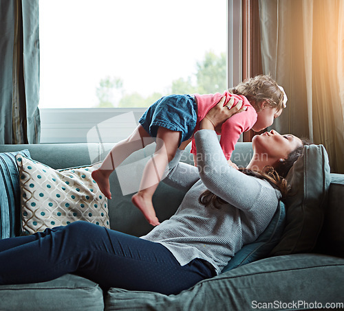 Image of Relax, happy and kiss with mother and baby on sofa for bonding, quality time and child development. Growth, support and trust with mom and daughter in family home for health, connection and care