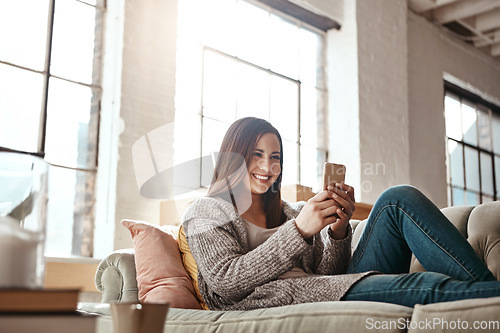 Image of Relax, phone and woman on a sofa, happy and texting on social media while resting in her home. Girl, smartphone and app for chatting, online dating and internet, search and streaming in a living room