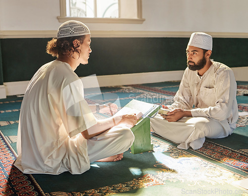 Image of Quran, muslim and mosque with an imam teaching a student about religion, tradition or culture during eid. Islam, book or worship with a religious teacher and islamic male praying together for ramadan