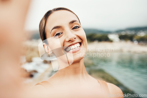 Image of Selfie, beach and travel with a woman tourist taking a picture outdoor during summer vacation or holiday. Portrait, face and smile with an attractive young female happy on the coast by the sea