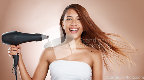 Image of Hair care, beauty and cosmetics of a woman with hairdryer on studio background for luxury keratin treatment with shampoo product. Headshot of female posing for salon, hairdresser and wellness mockup