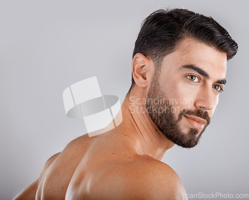 Image of Skincare, health and man in a studio for a hygiene, wellness and natural cosmetic face routine. Beauty, cosmetics and male model from Dubai with self care facial treatment isolated by gray background