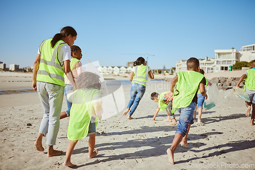 Image of Woman and group of children cleaning beach for volunteering, community and charity with earth day, climate change and education. Friends, teacher volunteer and recycle plastic for pollution learning