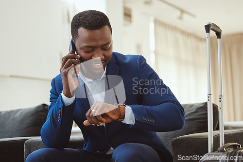 Image of African businessman in hotel, on smartphone call and checking wrist watch for time. Corporate professional in Chicago, young black entrepreneur and listening to voice message in luxury airport