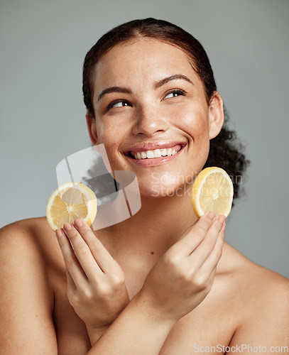 Image of Face, beauty and lemon with a model black woman in studio thinking about natural skincare or treatment. Happy, smile and idea with an attractive young female posing to promote diet or nutrition