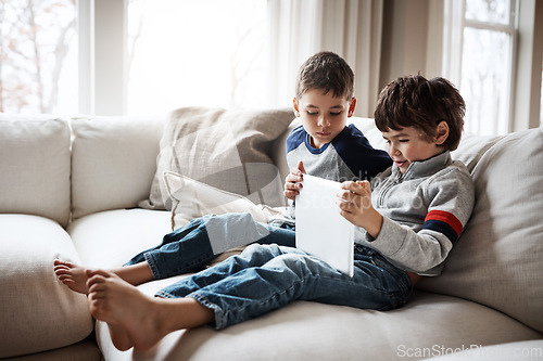 Image of Boys, bonding or tablet for movie streaming, social media, or esports gaming on family home sofa or living room. Kids, brothers or children on digital technology on education learning support or help