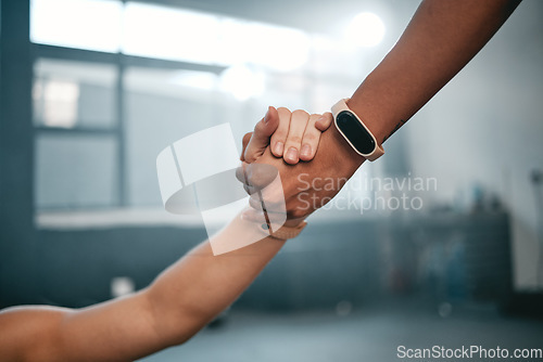 Image of Partnership, hands and motivation at gym by personal trainer and person for wellness, goal and help. Hand, support and people helping, encourage and lifting on weight loss, exercise and fitness guide