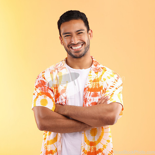 Image of Shirt, portrait and man with arms crossed in studio isolated on a yellow background. Fashion, aesthetic and happy, proud and confident man from Singapore in stylish, cool or designer tie dye clothing