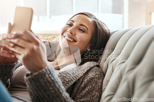 Image of Phone, woman and app for social media, relax and smile on a sofa, browsing and reading funny meme. Girl, smartphone and online dating, chatting and texting, streaming and lazy in a living room