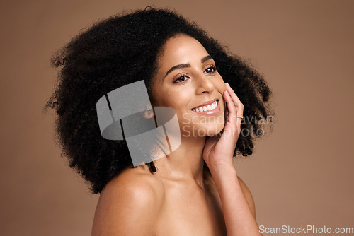 Image of Black woman, studio and happy with beauty, makeup and cosmetic wellness with hands, face glow or afro hair. Model, soft skin and facial cosmetics, self care and self love by brown studio background