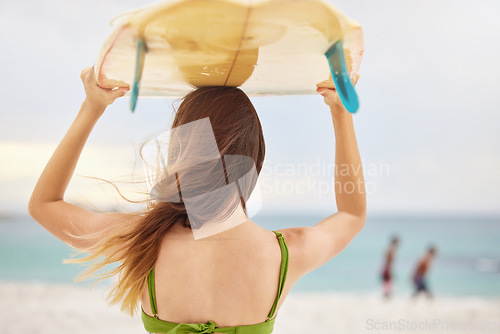 Image of Beach, fitness or woman with surfboard, freedom or calm peace watching the relaxing ocean waves on holiday vacation. Travel, back view or healthy girl athlete thinking of surfing goals or training