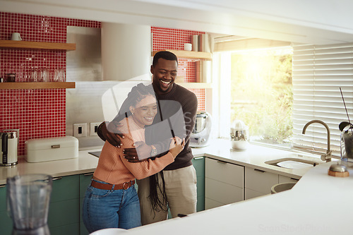 Image of Black couple, happy home and love while together with care and happiness in a marriage with commitment and care. Young man and woman laughing while in the kitchen to bond in their house or apartment