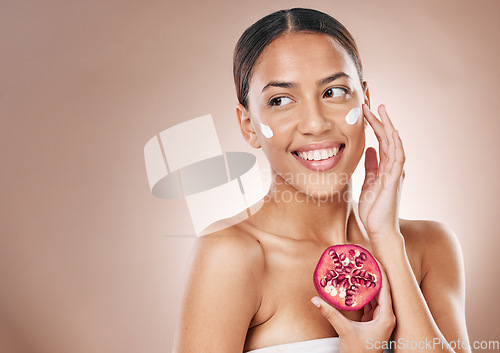 Image of Face, pomegranate cream and woman, beauty facial and wellness with skincare, healthy skin and cosmetic mockup. Glow, shine and vegan moisturizer, fruit and smile for facial with studio background