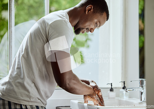Image of Black man, washing hands or bathroom sink soap in home healthcare wellness, hygiene maintenance or house self care. Smile, happy or handwash cleaning with tap for skincare grooming or bacteria safety