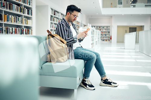 Image of Library, university and man with phone on sofa for education, research and checking social media. Networking, knowledge and male student on smartphone, mobile app and website in college bookstore