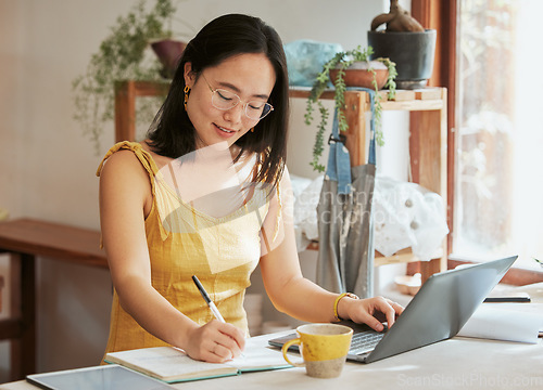 Image of Startup, Asian or business woman writing in notebook for SEO research, online communication idea or blog content search. Happy, smile or girl relax for social media, data planning or website review
