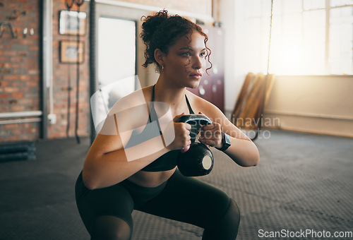 Image of Fitness, kettlebell and a woman at gym doing workout, exercise and weight training for body wellness and muscle. Strong sports female or athlete with weights for power, energy and a healthy lifestyle