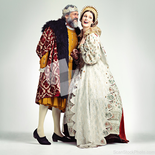 Image of King, queen and love in medieval costume for royal party, retro carnival and theatre fashion clothes in white background. Couple, happy face and talking in vintage renaissance isolated in studio
