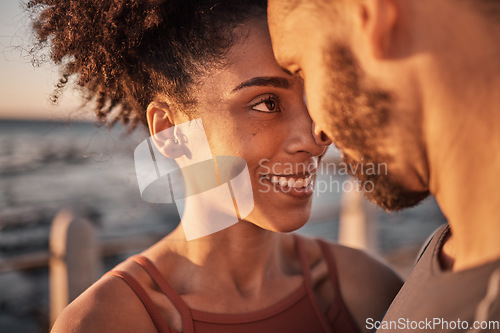 Image of Black couple, smile and hug with forehead embracing relationship, compassion or love and care by the beach. Happy man and woman touching heads smiling in happiness for support, trust or romance