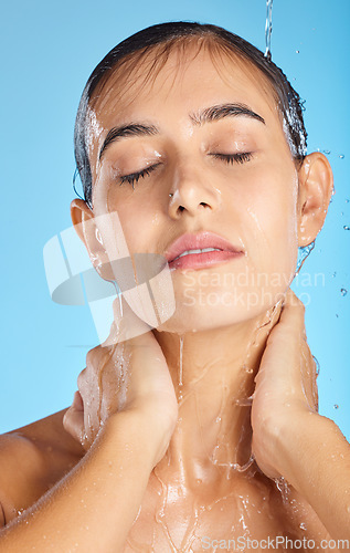 Image of Woman, shower water and face of a calm model ready for morning skincare and wellness. Blue background, studio and isolated female relax with peace from facial beauty cleaning and self care alone