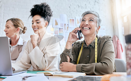 Image of Designer, fashion and senior woman on phone call with contact in workshop. Group collaboration, small business and teamwork of female tailors in boutique with laptop planning, talking and discussing.