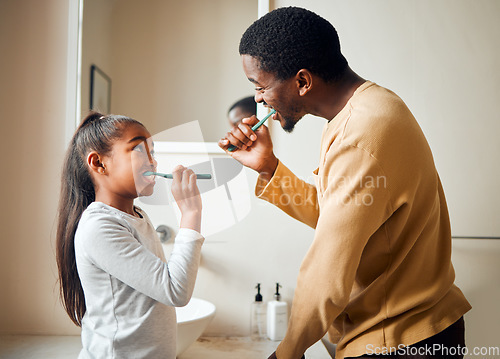 Image of Brushing teeth, bonding and father with daughter in a bathroom for hygiene and dental grooming. Oral, care and girl with parent, teeth and cleaning with black family, playful and learning at home